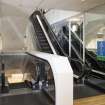 Interior.  Fourth floor.  View of escalators from south.