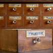 Coldstream, 61 High Street. Interior. Pharmacists medicine drawer. Detail showing 'FULLERS E.[arth]' drawer label (painted and gilded glass).