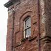Detail of upper stage of tower on north-west corner of Ravenscraig Hospital, Greenock. 