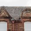 Detail pediments above first floor windows at west end of main entrance block of Ravenscraig Hospital, Greenock. 