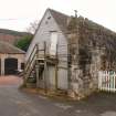 Standing building survey, W gable of S range showing the fore-stair and the E abutment of the courtyard entrance from SW, Courtyard Buildings, Kenmore Hotel