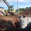 Watching brief photograph, The Snabs, Working shot, excavation of soakaway track (showing depth and location by garage)