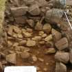 Excavation, Trench B, Working shot of N-facing kerb from N, Blasthill Chambered Tomb, 2009