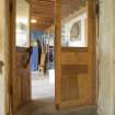 Interior view showing detail of door, including weighted closure system, in stables workshop at The Steading, Nether Blainslie.