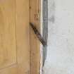 Interior view showing detail of weighted closure system on door in stables workshop at The Steading, Nether Blainslie.