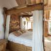 Interior view showing bed with 'broch' spiral in bed canopy in first-floor bedroom in extension to house at The Steading, Nether Blainslie.