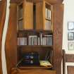 Interior view showing detail of cabinet with doors hiding utility meter in living room on ground floor of house at The Steading, Nether Blainslie.