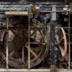 Interior.  Ground floor. Meal mill area. View of cast-iron pit wheel and remains of grinding stones machinery