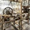 Interior.  Ground floor. Barley mill area. View from south west of pulley wheels and belts with waterwheel cast-iron pit wheel on right of image (east wall)