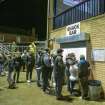 General view of snack bar at east end of main stand taken from the north west. Under floodlights.