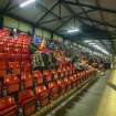 General view of the upper seating area of the main stand taken from the south east. Under floodlights.