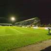 General view of football pitch to the main stand and east terracing taken from the south. Under floodlights.