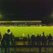 General view of football pitch to the main stand taken from the north. Under floodlights.