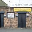 Detail south east turnstiles and football match notice.