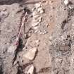 Archaeological excavation, General view of wall 109 and deposit 121 during excavation, Queen Street, Jedburgh