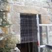 Watching brief, Working shot of the removal of 19th century masonry blocking the window of the Norman part of the church, 401-2 Strathbrock Parish Church, Uphall