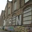 Detail of graffitti wall on southside of Dunnikier Works from east.