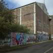 General view of graffitti wall on southside of Dunnikier Works from west.