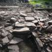 Intramural passage: upper layer of rough paving over fill of passage, and paved ramp up within entrance from courtyard