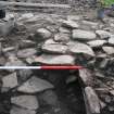 Intramural passage: upper layer of rough paving over lower layer, visible on left and accessed by ramp within entrance passage