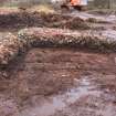 Trial trench evaluation, SW facing section through [1201] after removal of S quadrant of Cairn 1, Kilmelford, Argyll