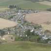 Oblique aerial view of Auchleven village, Aberdeenshire, looking NE.