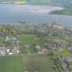 Oblique aerial view of Invergordon with the Cromarty Firth, Harbour and Balblair on the Black Isle, looking S.