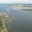 An oblique aerial view of Invergordon fabrication yard and Cromarty Bay and Black Isle, looking S.