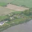 An oblique aerial view of Milton of Redcastle and Killearnan Church on N shore of the Beauly Firth, looking NE.