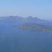 A distant oblique aerial view of Eigg and Rum, looking N.