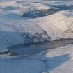 Oblique distant aerial view of Wyvis Lodge, near Evanton, under snow, looking NE.