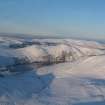 Oblique distant aerial view of Wyvis Lodge, near Evanton, under snow, looking NE.