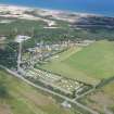 Oblique aerial view of the Findhorn Foundation and dunes beyond, Moray, looking N.