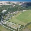 Oblique aerial view of the Findhorn Foundation and dunes beyond, Moray, looking N.