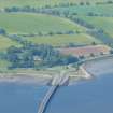 Oblique aerial view of north end of Cromarty Bridge and farmland at Ardullie, Black Isle, looking NW.
