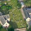Close near aerial view of Killearnan Church and burial ground at Redcastle on the north shore of the Beauly Firth.