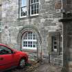 Evaluation Photograph, NE facing elevation- Phase 2- detail of rounded arch and decorative arrow loop to left, facing S, Old Coates House