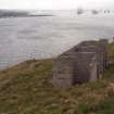 View from ENE of the latrines (9.43), showing the single concrete foundation block that anchored the mast to their N and the similar pair to their S 