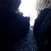 The narrow defile at the NE end of the cave leading out onto the rocky shore NW of the stacks 