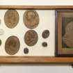 View showing contents of tenth drawer from the top of cabinet containing intaglios and wooden plaques.