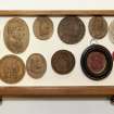 View showing contents of eleventh drawer from the top of cabinet containing intaglios and wooden plaques.