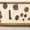 View showing contents of bottom drawer from cabinet containing intaglios and wooden plaques.