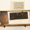 View showing contents of fifth drawer from the top of cabinet containing intaglios and wooden plaques.