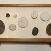 View showing contents of eighth drawer from the top of cabinet containing intaglios and wooden plaques.