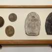 View showing contents of ninth drawer from the top of cabinet containing intaglios and wooden plaques.