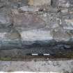 Watching brief, View of original wall face in drainage trench, Coldingham Priory