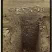 Excavation photograph of stone-lined pit in Lyne Roman Camp.