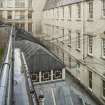 Fifth floor. View from balcony of Lightwell and glazed roof of Grand Hall. 