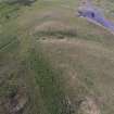 Oblique aerial view centred on the burial cairn, Fall Hill