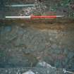 Archaeological evaluation, Test Pit 1 cobbled surface (103), 126-128 High Street, Dunbar